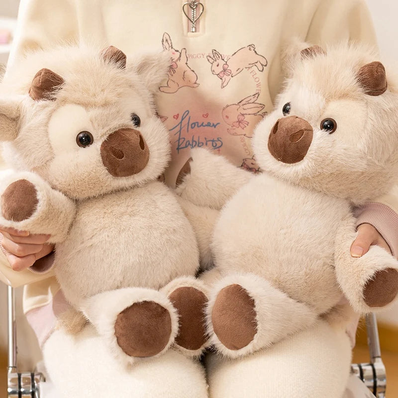 Close-up of two fluffy cow plushies being hugged
