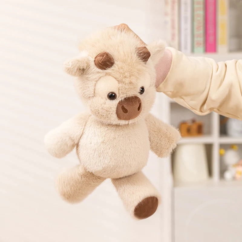 Running cow plush held by the head with its legs swinging